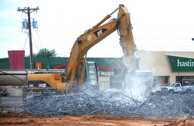Members of a construction crew sort material from the demolition of a FirstBank Southwest branch at the intersection of Southwest 45th Avenue and Teckla Boulevard.