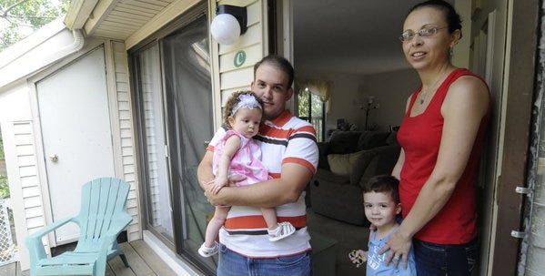 Renato Rodriguez, his wife, Liliane Brandal, right, daughter Laura Rodriguez, 6 months, and David Rodriguez, 3 next week, have been displaced recently while repairs are done to their Cape Crossroads apartment.