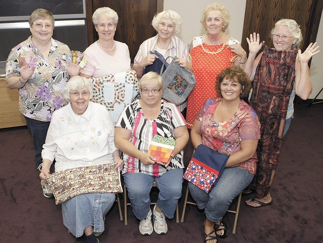 The Saint Barbs Catholic Church Caring Stitchers standing L to R, Bonnie Schillig, Cindy Smith, Alma Martin, Jen Dunbar, and Linda Burky. seated L to R, Shirley Tropea, Mary Sirgo, Chris Pape. Not pictured Mary Floyd, Judy Paquelet, Bev Myers, and Ruth Lamont.