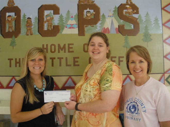 Pictured: Director of Extra Special People (ESP) Laura Whitaker was presented a check for $1,300 on May 16 from Katie Jennings, Oconee County Primary School (OCPS) Outreach committee chair, and Julie Patrick, OCPS Principal. OCPS raised over $4,000 this year through various fundraisers for three local charities - ACTS, Extra Special People (ESP), and Relay for Life.