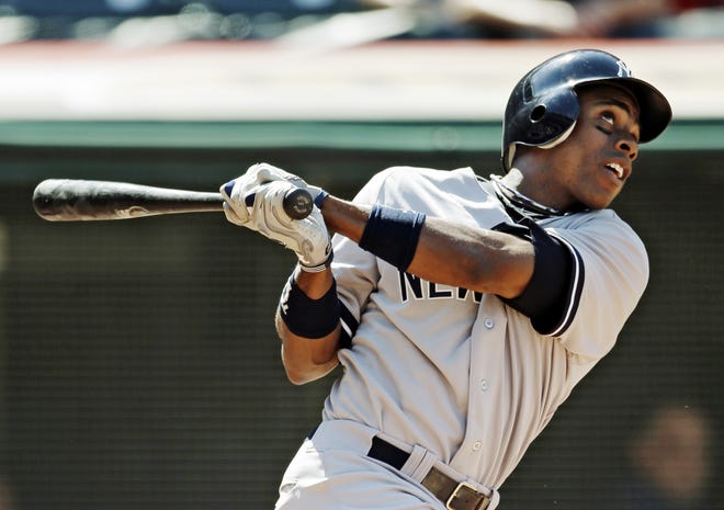 New York Yankees' Curtis Granderson watches his solo home run off Cleveland Indians pitcher Tony Sipp in the sixth inning of a baseball game, Sunday, Aug. 26, 2012, in Cleveland. ()