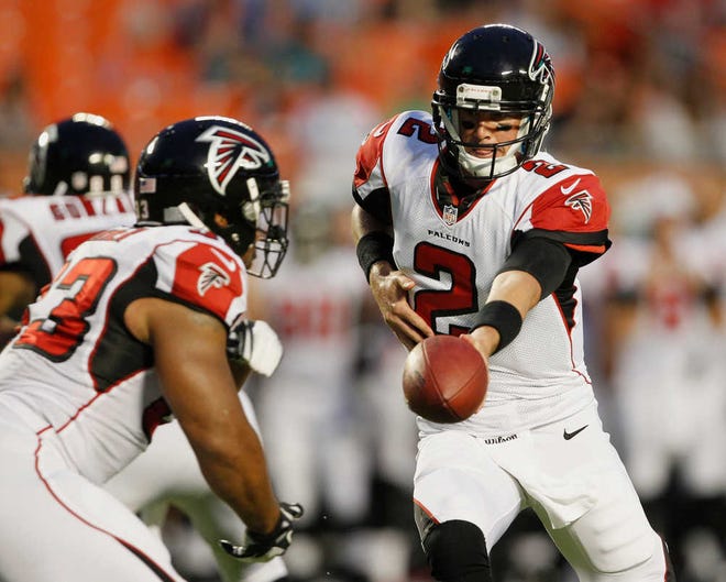 Atlanta Falcons quarterback Matt Ryan (2) hands the ball to running back Michael Turner (33) during the first half of an NFL preseason football game against the Miami Dolphins, Friday Aug. 24, 2012, in Miami. (AP Photo/Lynne Sladky)
