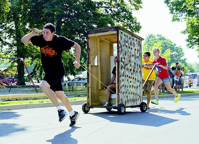 Michael Peterson leads the way in the Outhouse Races. Peterson, with Dakota Finley, Lgor Wayne, Alissa Bean and Kelsey Peterson, won the event.