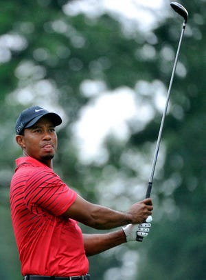 Tiger Woods watches his tee shot on the third hole during the final round of the Bridgestone Invitational golf tournament at Firestone Country Club in Akron, Ohio, Sunday, Aug. 5, 2012. (AP Photo/Phil Long)