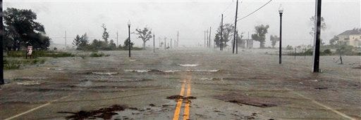 Isaac's winds and storm surge flood parts of Waveland, Miss., on Wednesday, the seventh anniversary of Hurricane Katrina hitting the Gulf Coast.