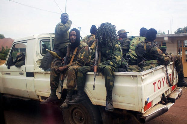 Congolese FARDC (Forces Armees de la Republique Democratique du Congo) sit with their weapons on a pickup truck outside Goma, eastern Congo.