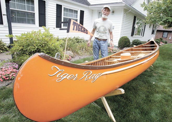 Washington High School graduate Tom McCloud talks about his 1938 antique canoe he restored and had painted Tiger orange and named the "Tiger Rag" as it has been covered in stretched canvas.