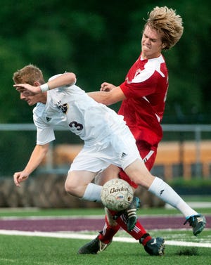 Morton's Ben Willett, right, and Dunlap's Ryan Kocher collide while chasing the ball Tuesday night at Dunlap High School.