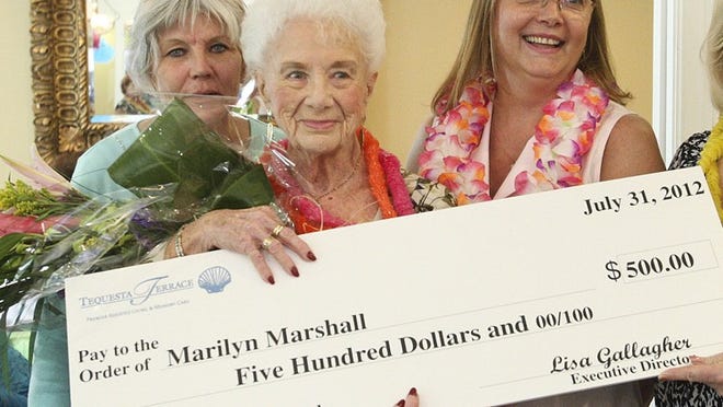 Marilyn Marshall (center), 89, didn’t expect to be honored with the Tequesta Terrace Assisted Living Senior Service award for her work at the Our Sister’s Place Thrift Shop. Presenting her with a check for $500 are Karen Kenneth-Schmid (left), Tequesta Terrace’s community outreach director, and Lisa Gallagher, the senior community’s executive director.