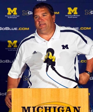 FILE - In this Aug. 12, 2012, file photo, Michigan head coach Brady Hoke answers questions during a news conference at the NCAA college football team's media day in Ann Arbor, Mich. Michigan is scheduled to play Alabama for just the fourth time on Saturday, Sept. 1, at Cowboys Stadium in Arlington, Texas, despite having combined for 1,709 wins and 25 national titles. (AP Photo/Tony Ding, File)
