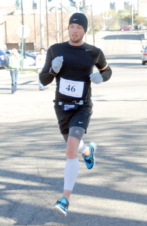 n Massillon resident Christopher Craver approaches the finish line of the Tiger Trot Run on Saturday morning. Craver won in a time of 17:17.75 to become the first city resident to win the event. Leslie Slyman of Copley won the women’s race.