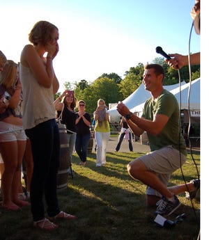 Josh Dennie got down on one knee, and popped the question to Kristen Tracy in front of 20 family and friends at the concert.