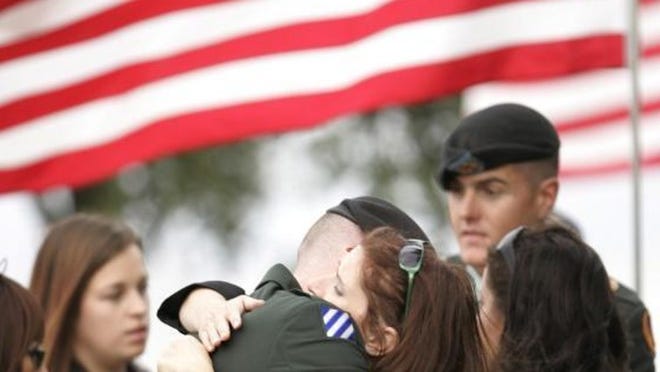 Soldier from Terrell laid to rest Spc. James Dansby hugs Shellye Wright at the funeral of their cousin, 26-year-old Spc. Joseph M. Lewis, on Saturday in Terrell. Lewis was killed by a roadside bomb in Kandahar, Afghanistan, on Nov. 17, according to the Department of Defense. Dansby escorted Lewis' body home to Texas.