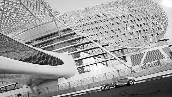 The Yas Hotel, where spectators can watch the races, looms above the Formula One track in Abu Dhabi. About 100 million fans tune in via television. The architectural firm that designed Yas is on board for Formula One Austin.