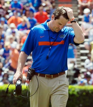 FILE - In this April 7, 2012, file photo, Florida coach Will Muschamp pushes his hair back during the Orange and Blue NCAA college football game in Gainesville, Fla. Florida opens the season against Bowling Green Saturday. (AP Photo/Phil Sandlin, File)