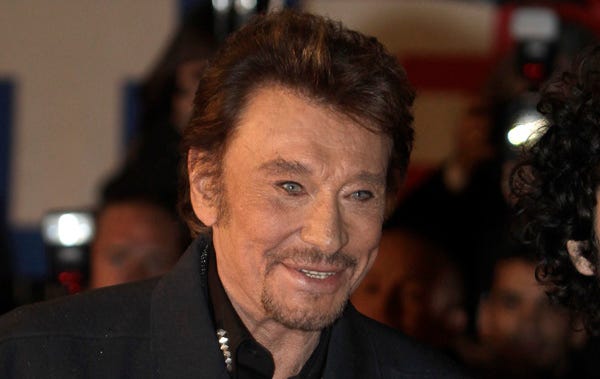 FILE - In this Saturday, Jan. 28, 2012 file photo, French singer Johnny Hallyday arrives at the Cannes festival palace, to take part in the NRJ Music awards ceremony, in Cannes, southeastern France. Hallyday, the French entertainer famed for his Elvis-like style and gravelly voice, was hospitalized for a severe case of bronchitis in Guadeloupe, his producer said Monday, Aug. 27, 2012.