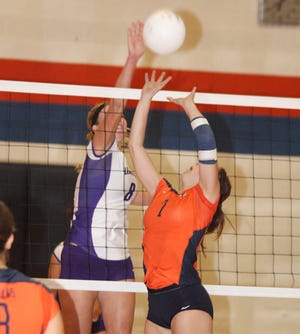 Erica Davis of Lexington taps the ball as Pontiac’s Haley Fairfield also goes after it during Thursday’s match at PTHS.