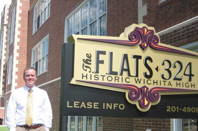 Jason Van Sickle, president of J. Van Sickle & Co., stands in front of Flats-324 apartments, which was his first apartment project in Wichita.