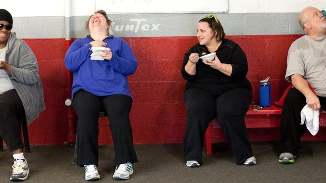 Julia Robinson photos for AMERICAN-STATESMAN From left, Gina McCauley, Melissa Schlabach and Marcy Baldanza enjoy a complimentary MyFitFoods meal, included in the group membership fee, as Larry Brewer rehydrates after a group workout. The annual fee also includes a pair of running shoes.