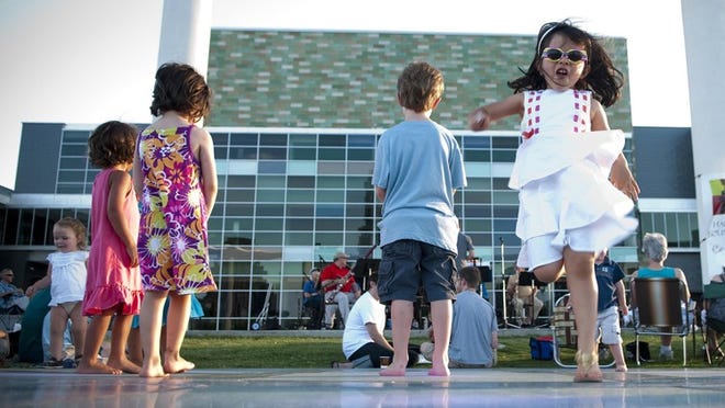 Isabella Matamoros, 3, dances to the sounds of the Austin Symphony Chamber Winds during the Hartman Councerts in the Park series.