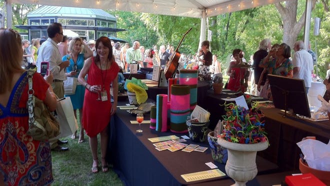 Guests browse auction items at the 2011 Umlauf Garden Party. This year's event will take place April 26.