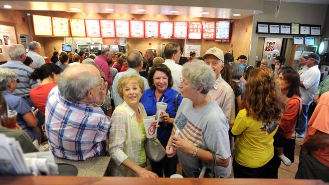 Verlene Edgmon, Glenda Penney and Laura Pool wait in line to receive their food Wednesdya at a Chick-fil-A in Tyler. Hundreds of people purchased food at Chick-fil-A restaurants as part of "Chick-fil-A Appreciation Day," a day to support the company after recent media backlash stemmed from its founder's stance against gay marriage.