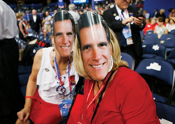 Michigan delegates Carol Knoblauch of Riga, left, and Barbara Brady model their masks of Republican presidential nominee Mitt Romney on Thursday at the Republican National Convention in Tampa, Fla.