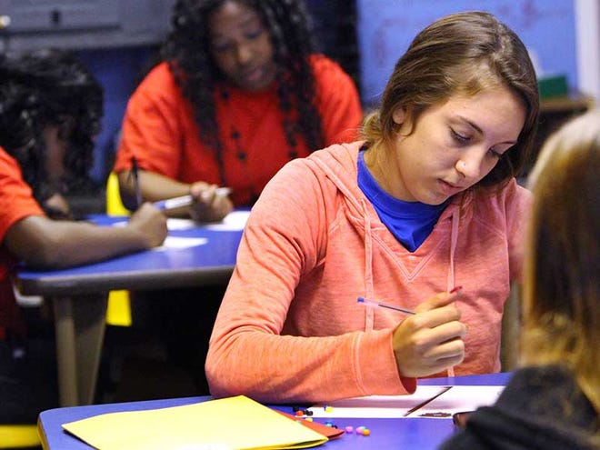 Vanessia and other students work on an English assignment at the Pace Center for Girls in Ormond Beach on Friday.