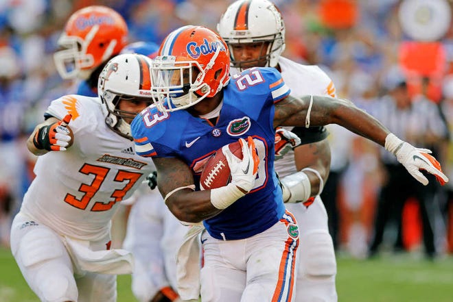 Florida running back Mike Gillislee (23) rushes as Bowling Green linebacker Paul Swan (33) tries to stop him during the second half of an NCAA college football game, Saturday, Sept. 1, 2012, in Gainesville, Fla. Florida won 27-14. (AP Photo/John Raoux)