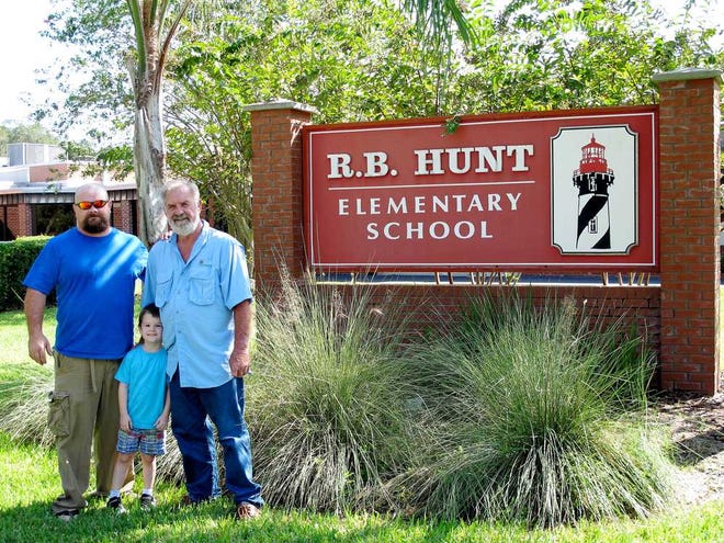 David, Vincent and James Craig pose on the grounds of the R.B. Hunt Elementary School on opening day. Contributed photo.