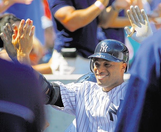Yankees second baseman Robinson Cano is congratulated after homering in New York's 4-3 win over Baltimore on Saturday.