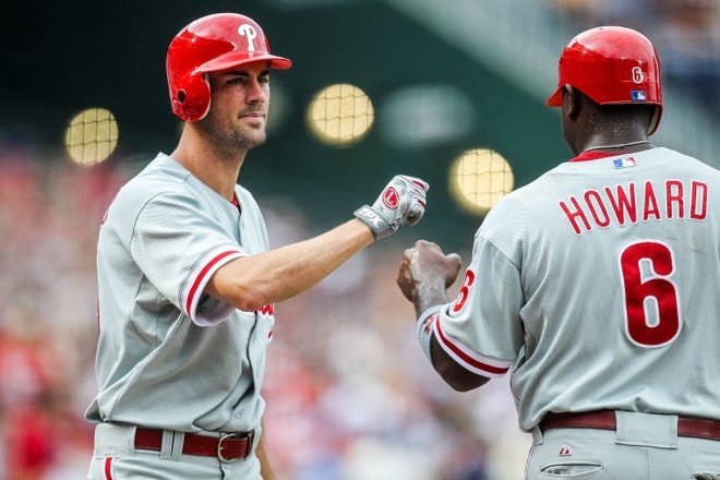 Philadelphia's Ryan Howard (6) celebrates with Cole Hamels after scoring a run in the first inning against the Atlanta Braves on Sunday.