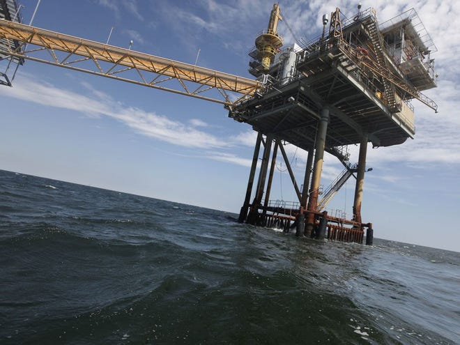 In this Tuesday, April 27, 2010 file photo, An oil rig is seen in the Gulf of Mexico near the Chandeleur Islands, off the Southeastern tip of Louisiana. Energy companies have reoccupied nearly 400 of the production platforms in the Gulf of Mexico that were abandoned in advance of Hurricane Isaac, though oil production remains almost entirely shut down. Oil and gas workers began retaking the offshore sites Friday and federal officials on Saturday, Sept. 1, 2012 say that 377 of the 596 productions platforms have some staffing on them, up from just 97. (The Associated Press)