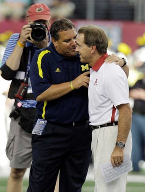 Michigan head coach Brady Hoke, left, greets Nick Saban before their game at Cowboys Stadium LM Otero)