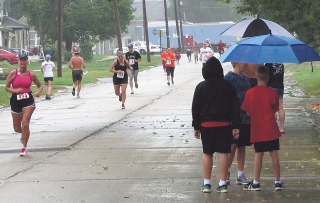 Runners and spectators didn’t let the rain stop them from enjoying Saturday morning’s Hog Stampede. More Hog Days photos are on Pages A7, A10 and B10.