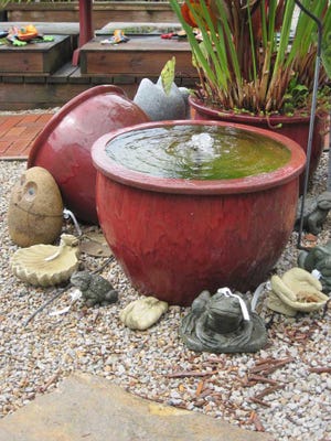 Photos courtesy of Universal Press Syndicate Water splashes out of a glazed pot in a display at a water-garden shop. Water-garden specialty shops often sell urns and vessels of all sizes, and the pumps and fittings you need to turn them into fountains. It's an easy Saturday project.