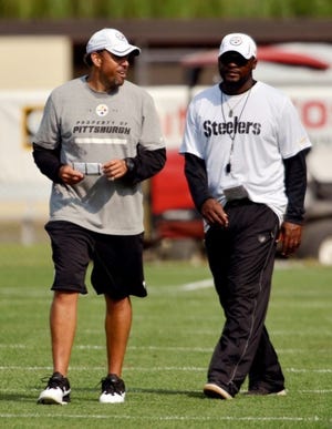 Steelers offensive coordinator Todd Haley, left, talks with head coach Mike Tomlin during Pittsburgh Steelers training camp at St. Vincent College in Latrobe, Pennsylvania, on Wednesday, August 1, 2012.
