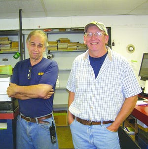 Ronnie Currey, left, and Dave Pentz are part-owners of Antrim Auto Parts. Three generations of the family work at the business. Pentz wants to pay tribute to garage owners of the past. He plans to dedicate wall space to pictures of deceased operators.