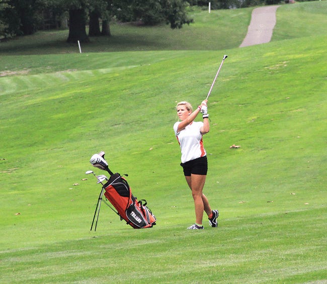 Taylor Clark hits her approach shot that went in the hole Wednesday on No. 12 at Klinger Lake County Club.