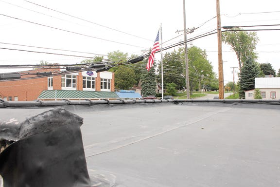The Addison Village Council on Tuesday approved a $3,680 bid from Colin Punches to fix the roof on top of the village hall and library. Punches will install a vented, seamless, rubber roof. Telegram photo by Dan Cherry