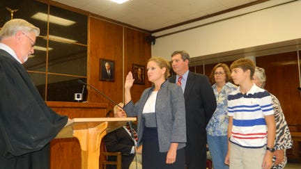 Terry Frank is sworn in as Anderson County mayor last Friday. She's surrounded by family. Judge Don Layton is swearing her in.