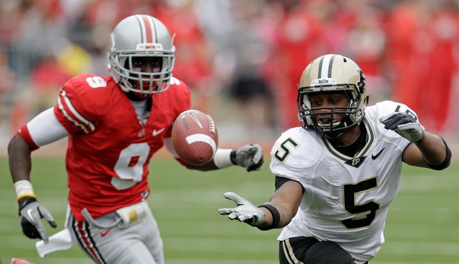 Purdue running back Al-Terek McBursehalf (5) can't hold onto a pass as Ohio State defensive back Adam Griffin (9) moves in during the second half of an NCAA college football game Saturday, Oct. 23, 2010, in Columbus, Ohio. Ohio State won 49-0.