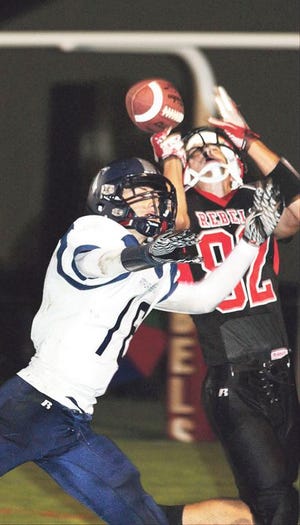 Stark County’s Clayton Kieser (82) tries to haul in a pass over A-W defender Grant Baele (16).