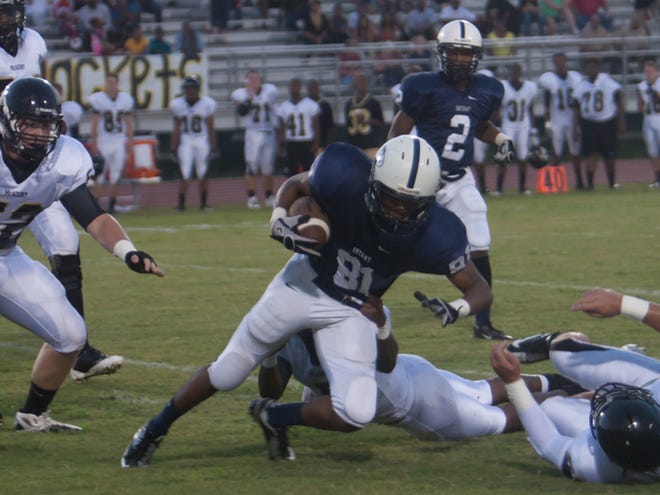Bryant's Tionne Wilder (81) runs the ball in Friday night's game at Paul Bryant High School.