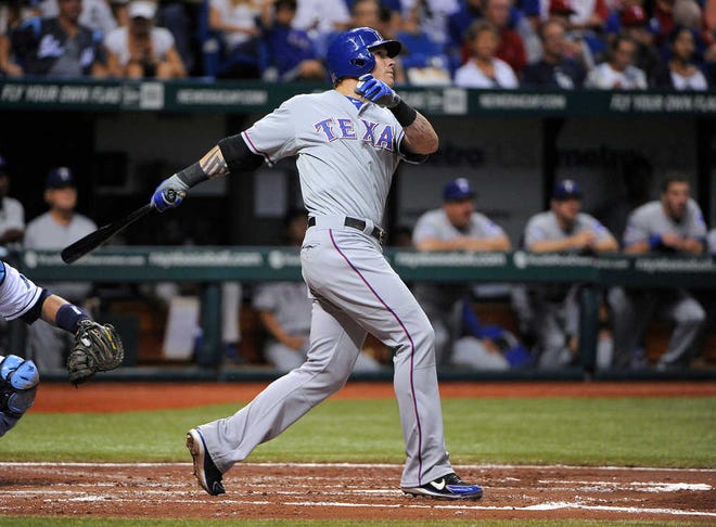 Texas Rangers' Josh Hamilton follows through on a two-run home run off Tampa Bay Rays starting pitcher Chris Archer during the fourth inning of their game Saturday night in St. Petersburg, Fla. The Rangers won, 4-2, in 10 innings.