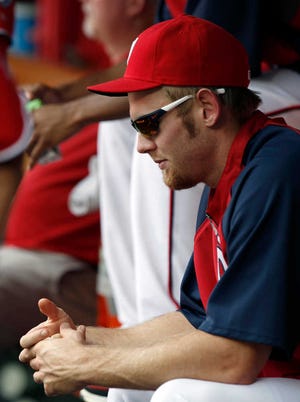 Washington Nationals pitcher Stephen Strasburg sits in the dugout Saturday, the same day the club announced Strasburg's season is over.