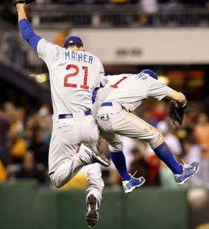 The Cubs' Joe Mather (21) and Tony Campana (1) leap in celebration after beating the Pirates 4-3 at PNC Park on Saturday night.