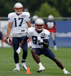 Patriots wide receiver Brandon Lloyd (85) cuts as wide receiver Greg Salas (17) watches during the team's practice on Wednesday.