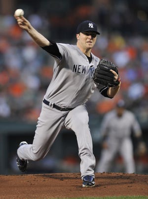 New York Yankees starting pitcher Phil Hughes delivers against the Baltimore Orioles in the first inning of a baseball game Friday, Sept. 7, 2012, in Baltimore. ()
