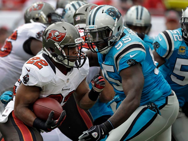 Buccaneers running back Doug Martin (22) cuts away from Panthers defensive end Charles Johnson (95) during the first quarter Sunday in Tampa. The rookie ran for 95 yards on 24 carries in his NFL debut.